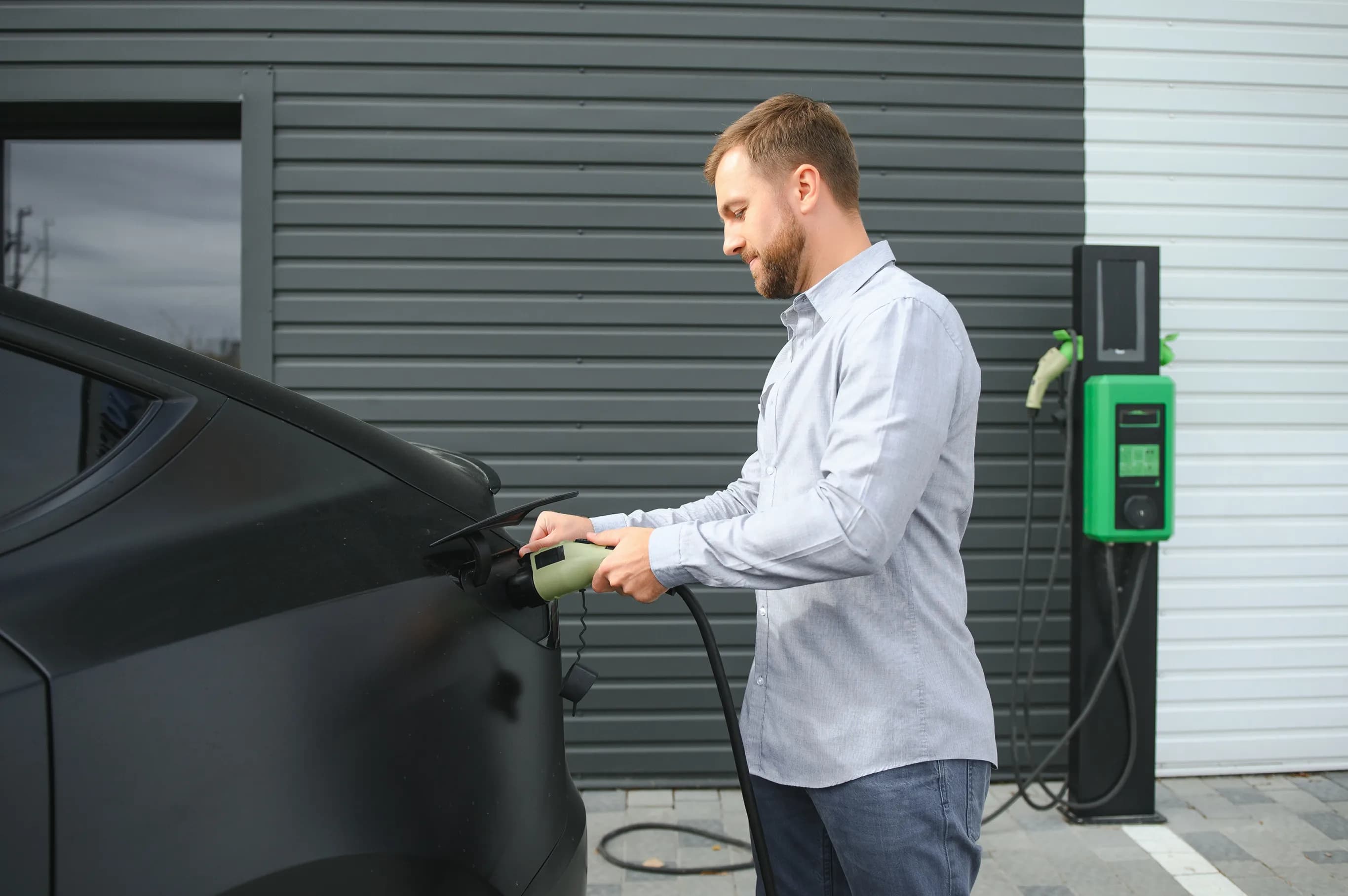 Man charging Black Tesla Model X