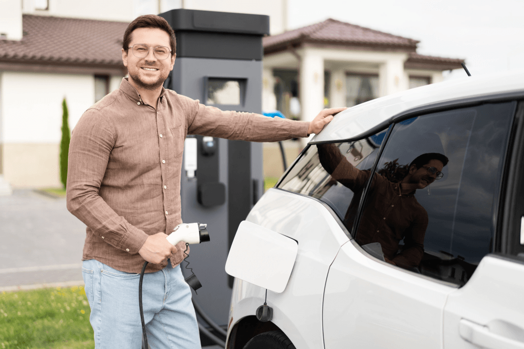 Woman holding phone and charging car